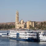 Christmas Nile cruise overlooking Luxor temples and a traditional felucca at sunset